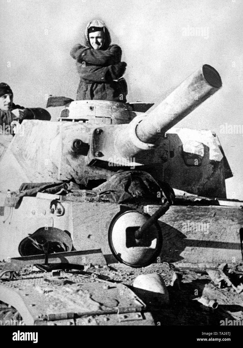 The crew of a battle tank (presumably Panzer III) tries to keep warm at sub-zero temperatures. Photo of the Propaganda Company (PK): war correspondent Lessmann. Stock Photo