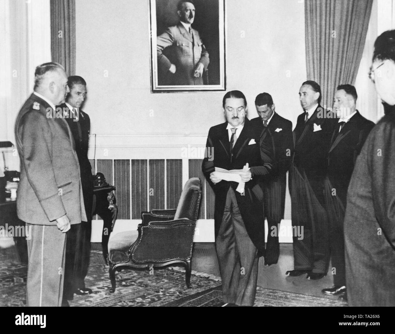 The government of the Protectorate of Bohemia and Moravia after the occupation of Czechoslovakia by the National Socialists. From left to right: Reichsprotektor Konstantin von Neurath, Prime Minister Alois Elias (center), Minister of Transport Jiri Havelka, Agriculture Minister Ladislav Karel Feierabend, Minister of Finance Josef Kalfus and Minister Dr. Ing. Sadek. In the background, a portrait of Adolf Hitler. Stock Photo