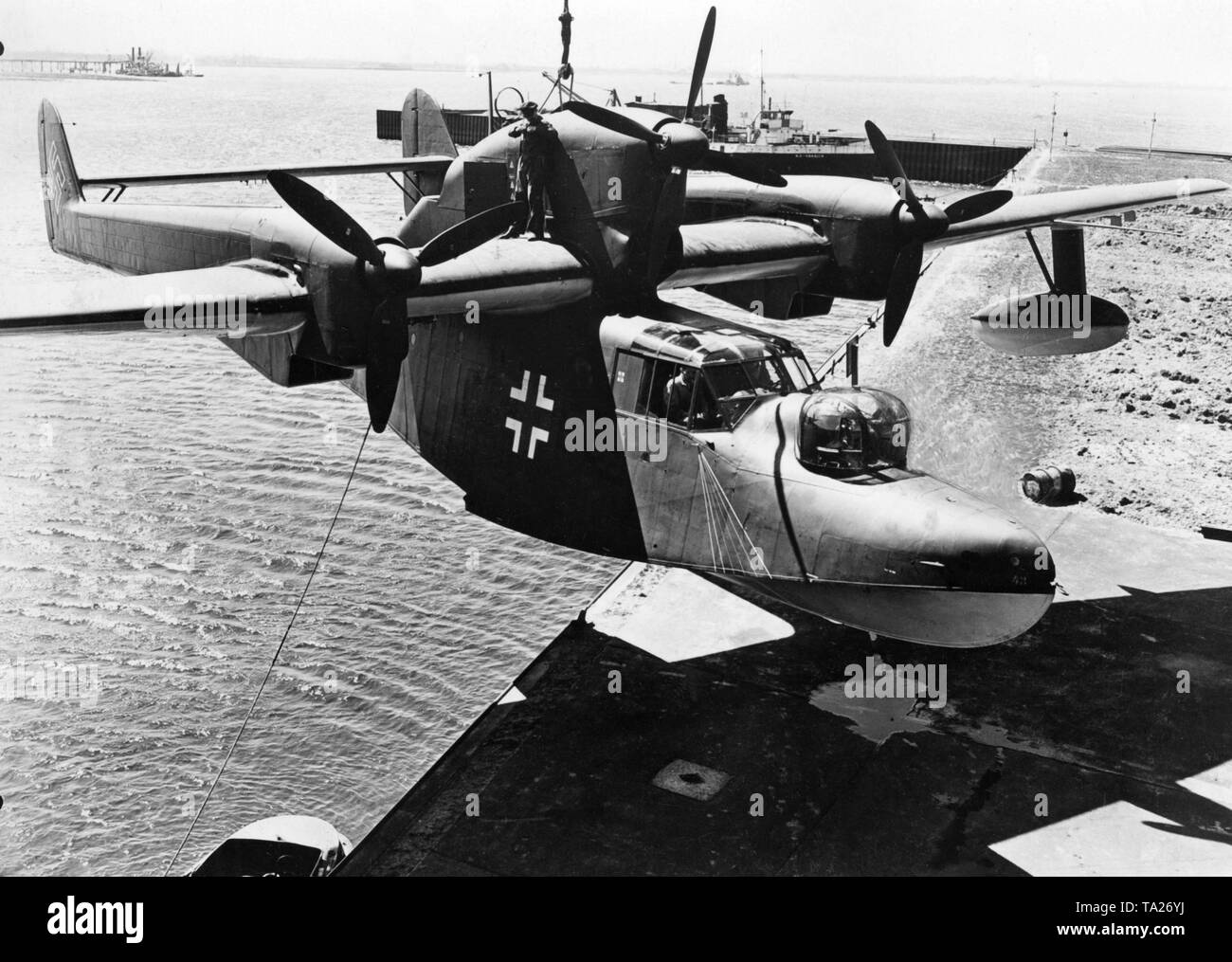 A Blohm & Voss BV 138 flying boat is lowered into a harbor basin Stock Photo Alamy