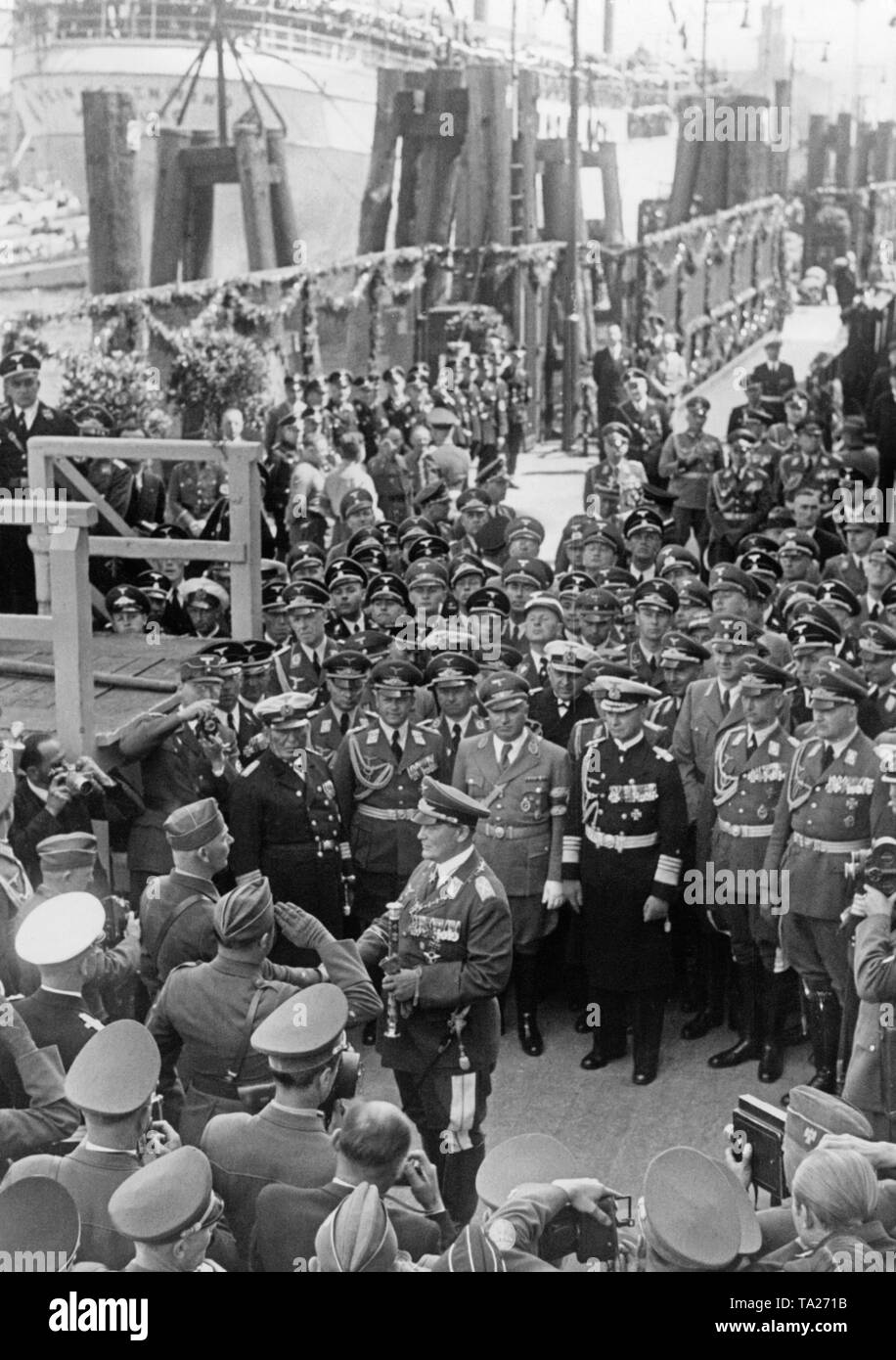 On the arrival of the Condor Legion from Spain, Field Marshal General, Hermann Goering (on the right with the general's baton), greets major general Wolfram von Richthofen (left) on the gangway in St. Pauli district of Hamburg. In the first row Colonel-General Erhard Milch, Robert Ley and General Admiral Conrad Albrecht, as well as prominent figures of the military. Stock Photo