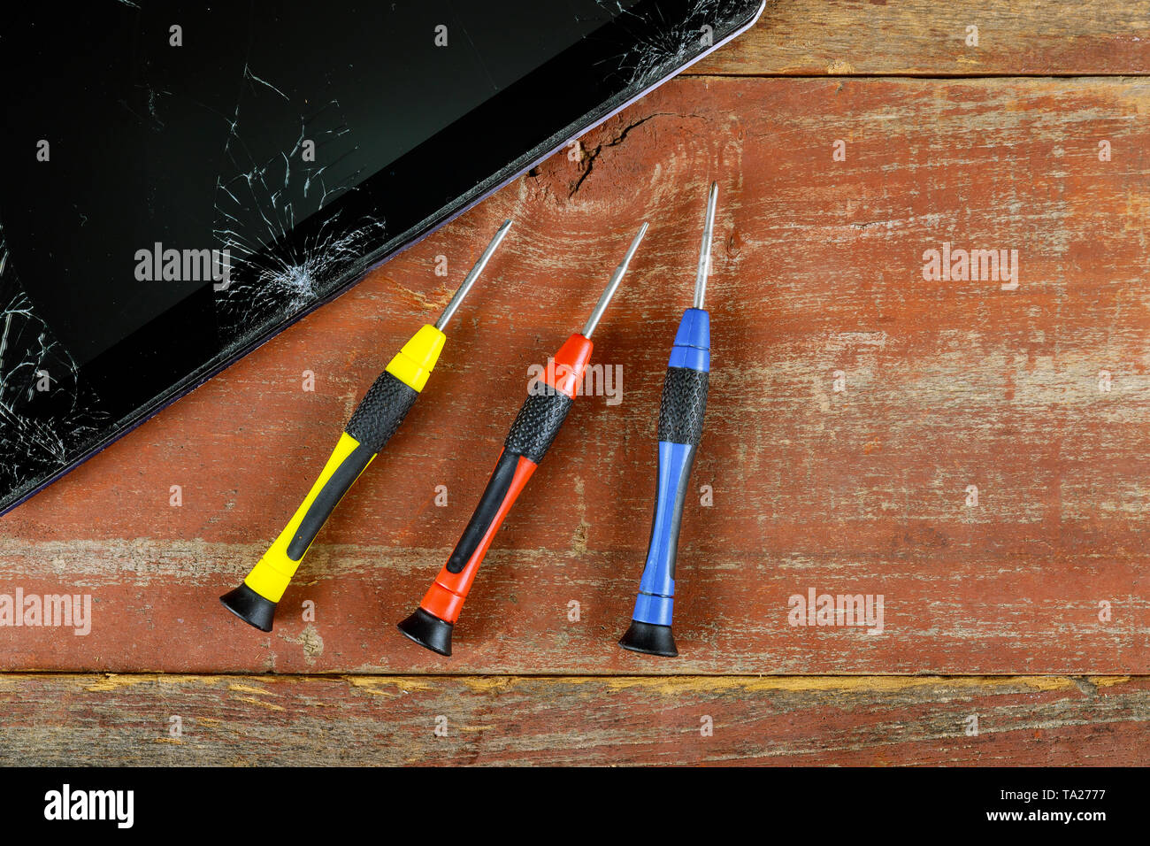 Technician repairing inside of tablet screwdriver in the mobile phone electronic repairing technology. Stock Photo