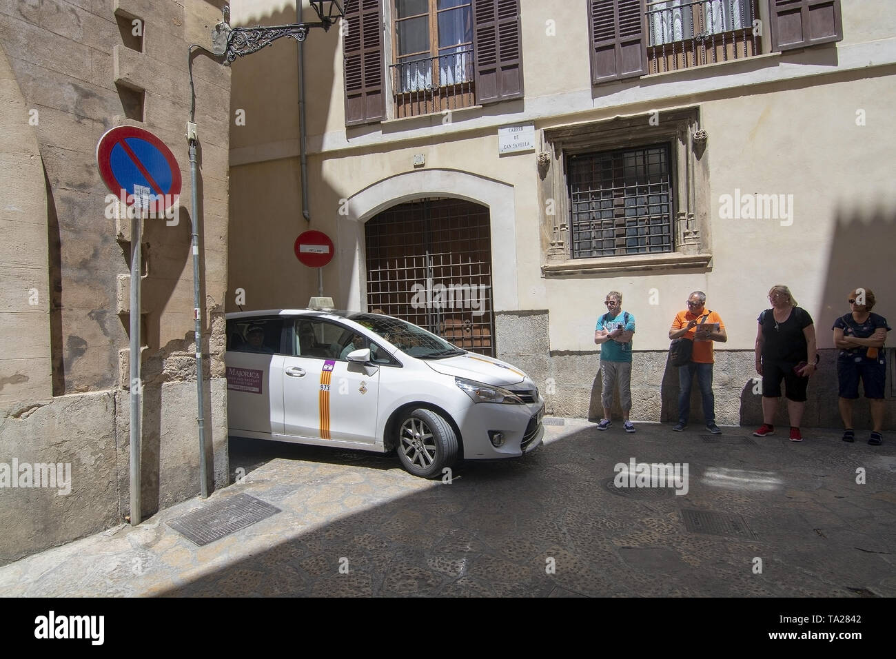 PALMA, MALLORCA, SPAIN - MAY 20, 2019: Taxi approaching in narrow alley on May 20, 2019 in Palma, Mallorca, Spain. Stock Photo