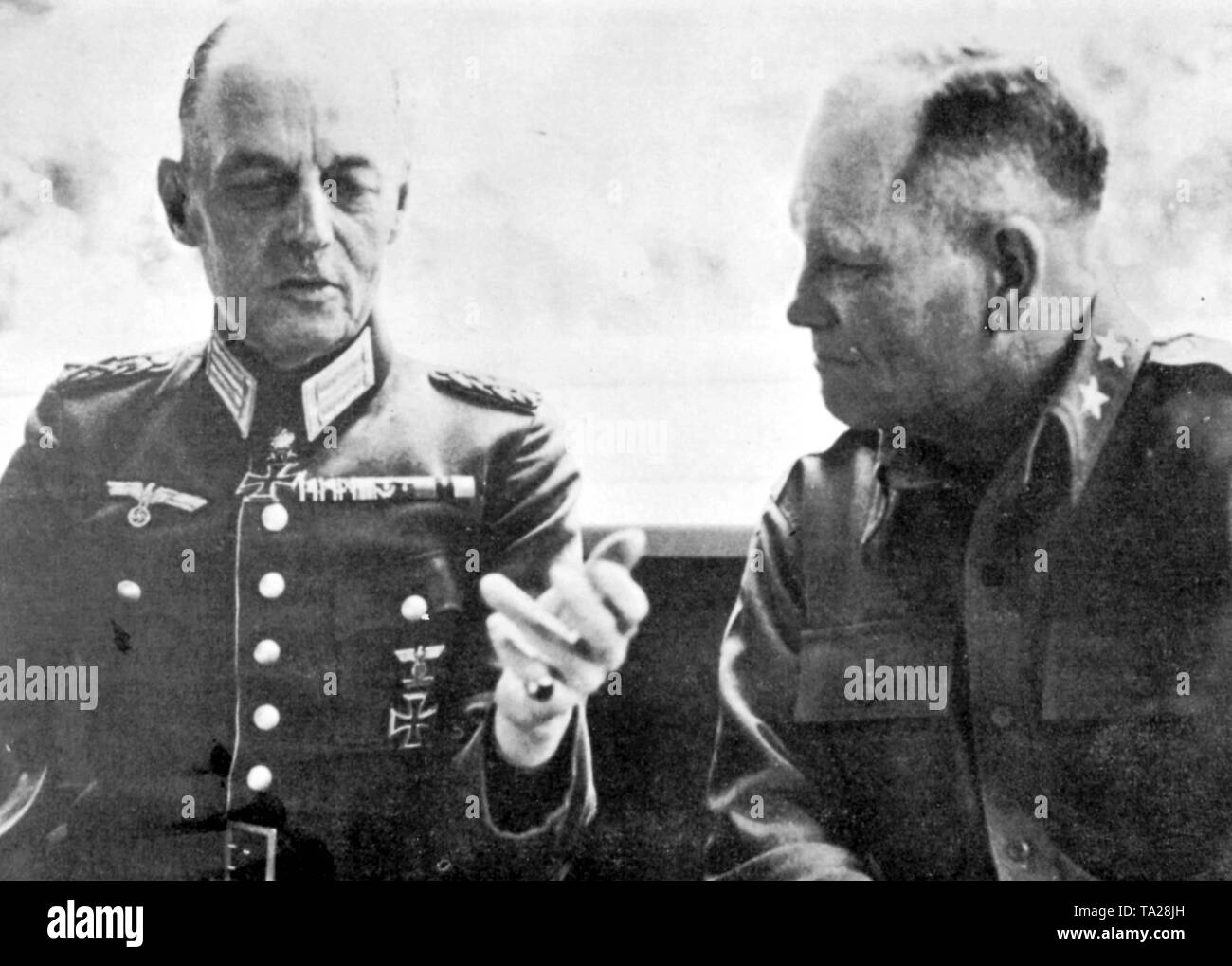 The captive German Field Marshal Gerd von Rundstedt talking to the US General Frank W. Milburn. Stock Photo