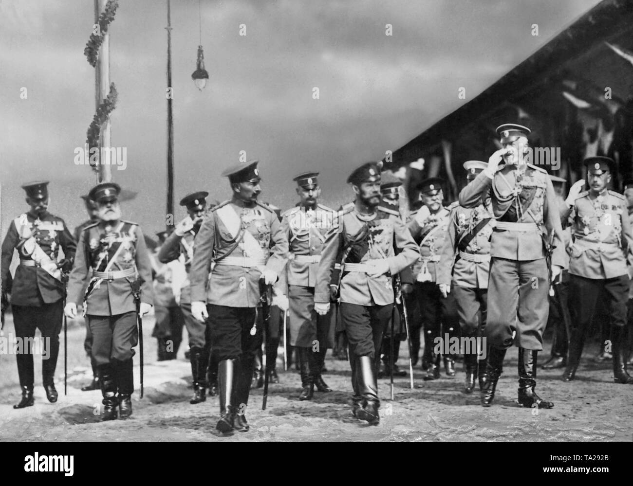 Emperor Wilhelm II (3rd from left), Tsar Nicholas II (4th from left) and Grand Duke Nikolai Nikolaevich (5th from left) take the salute of the Vyborg regiment at the leaders meeting in Baltischport. Stock Photo