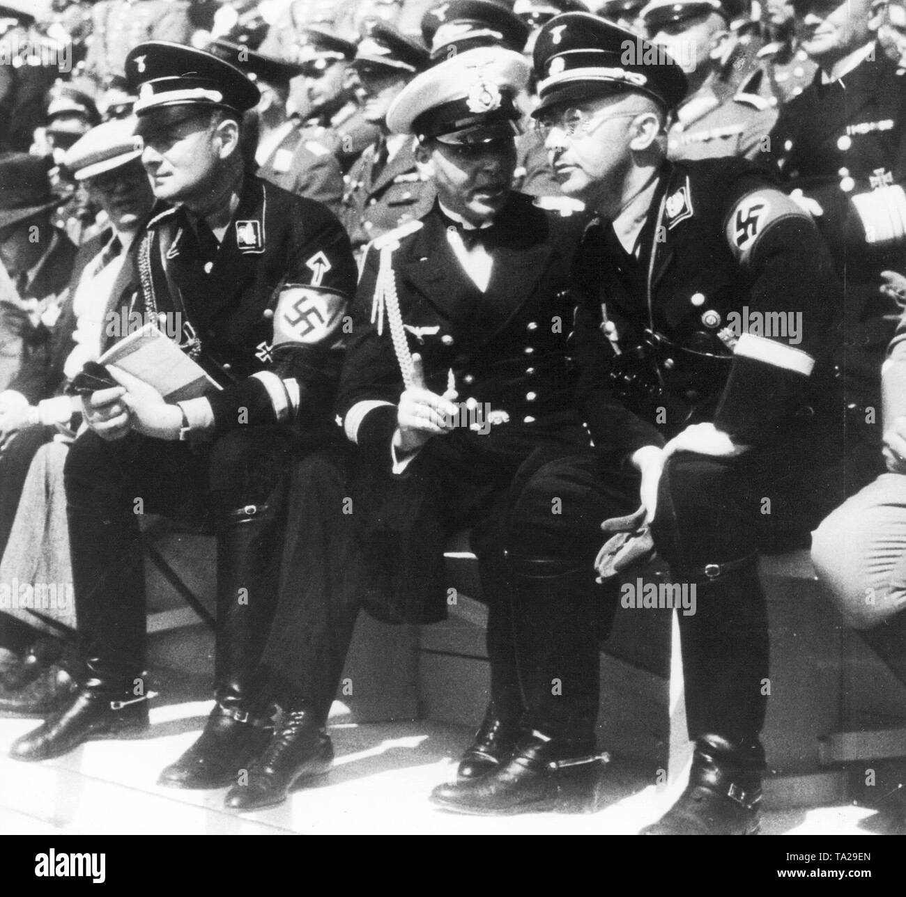 Reichsfuehrer-SS Heinrich Himmler (right) talking to a naval officer. On the left, Himmler's adjutant Karl Wolff. Stock Photo