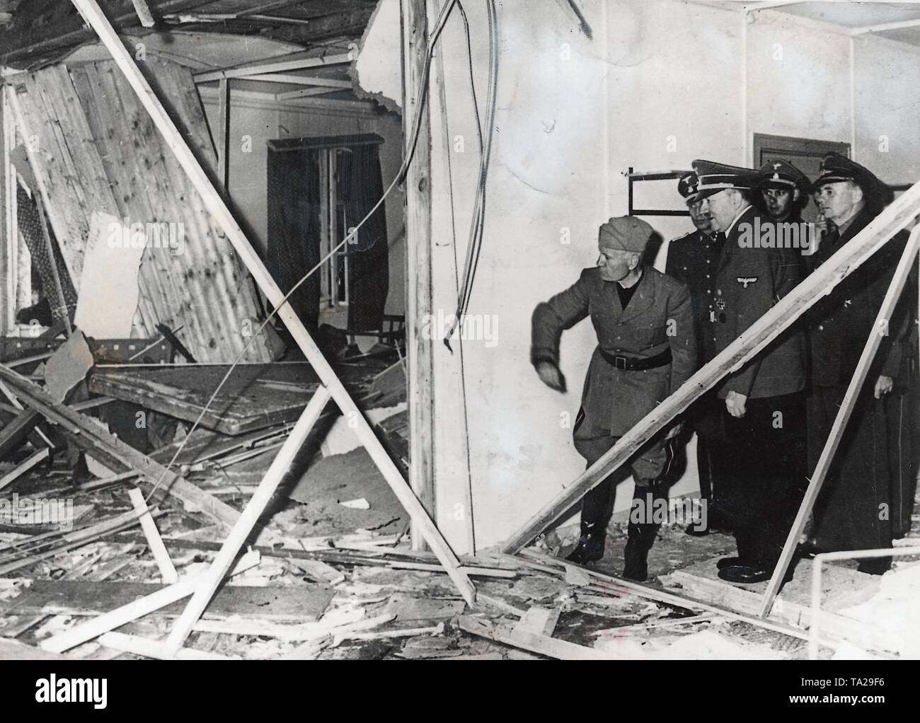 Adolf Hitler and Benito Mussolini in the ruined briefing room on the day of the assassination attempt of von Stauffenberg in the headquarters 'Wolf's Lair' near Rastenburg / East Prussia, on July 20, 1944. Mussolini arrived on a previously planned visit on the same day. Stock Photo