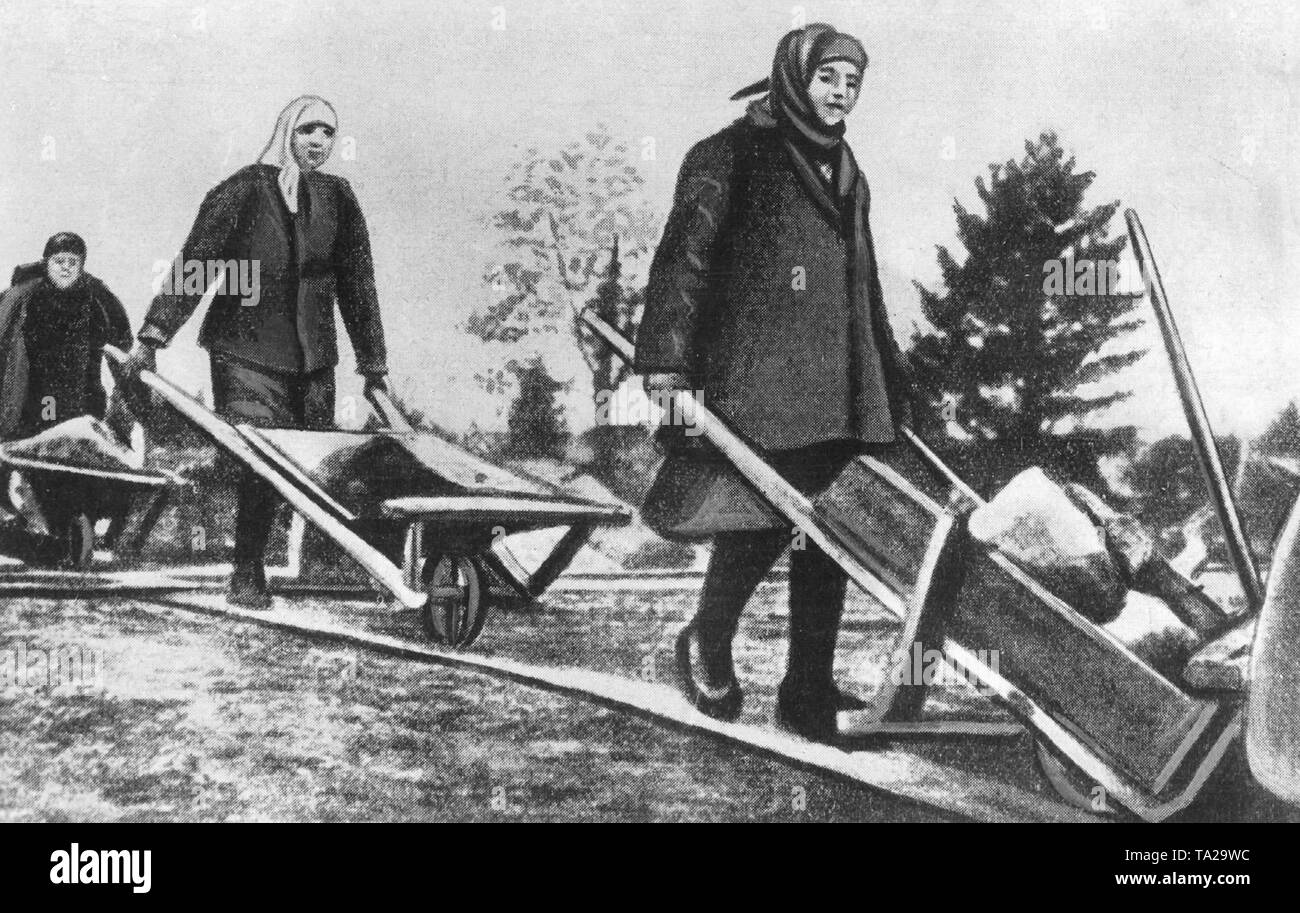 Exiled women doing heavy physical work in a Soviet labor camp. Stock Photo