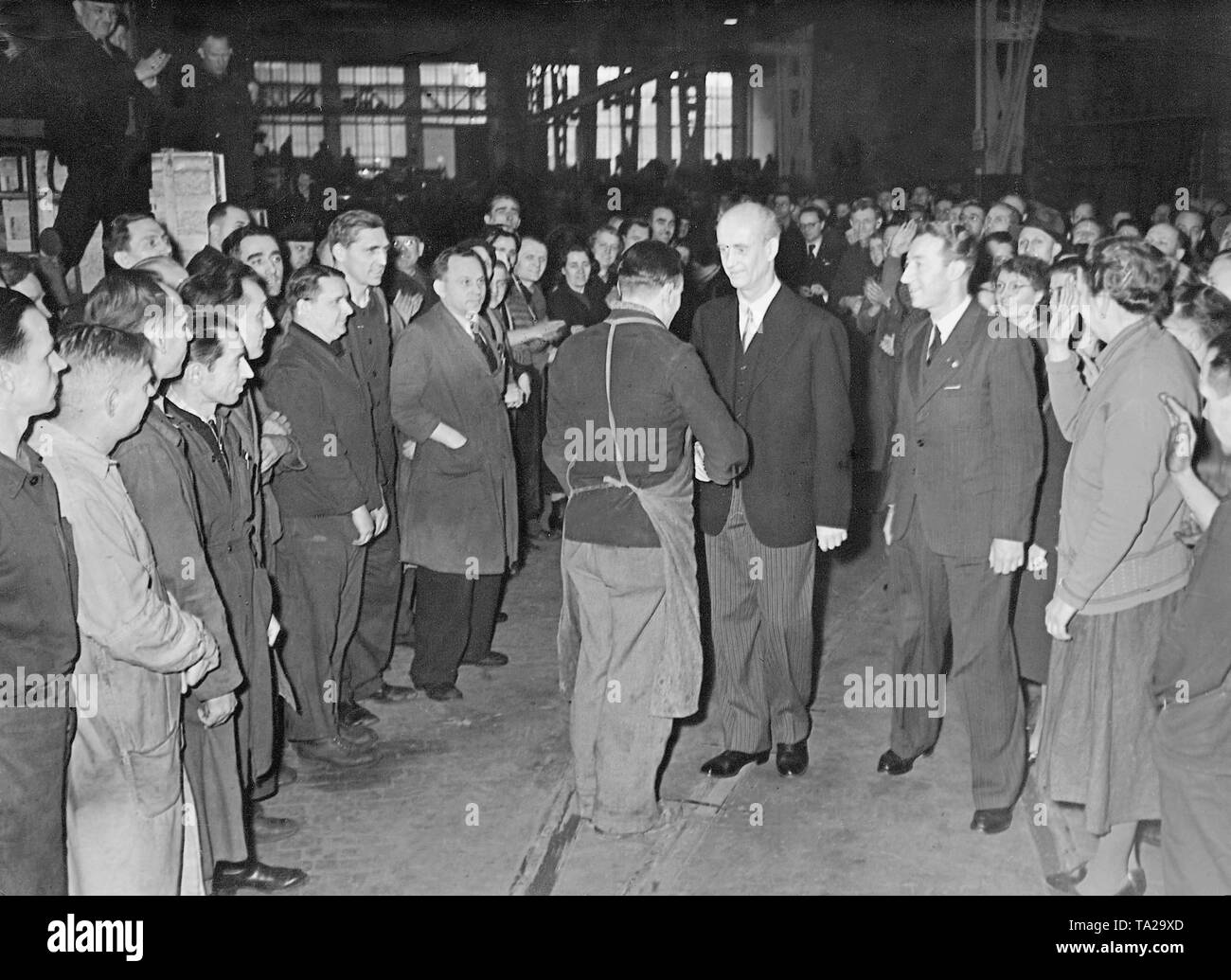 Wilhelm Furtwaengler, German conductor and composer, gave a so-called Werkspausenkonzert with his Berlin Philharmonic at the AEG in the Brunnenstrasse. In the picture, one of the workers thanks in the name of his colleagues for the performance. The concert was organized by the Nazi organization 'Kraft durch Freude' ('Strength through Joy'). Stock Photo