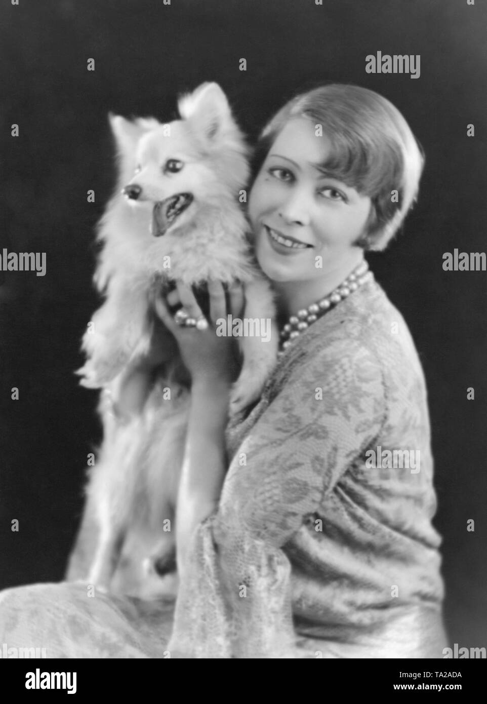 Portrait of a woman - and her dog - with contemporary hair fashion of the 1920s: the bob. Stock Photo