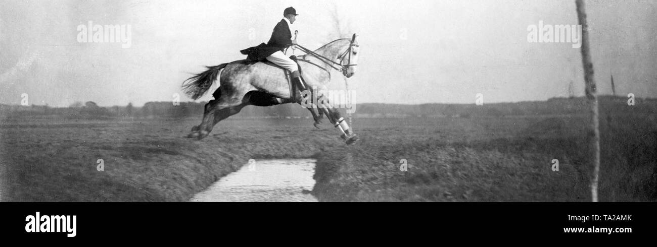 The Crown Prince Couple as guests during a par force hunt with Mr. Elard von Oldenburg-Januschau. Here, the Crown Prince (in front) together with Count Posadowsky at the first ditch jump. Stock Photo