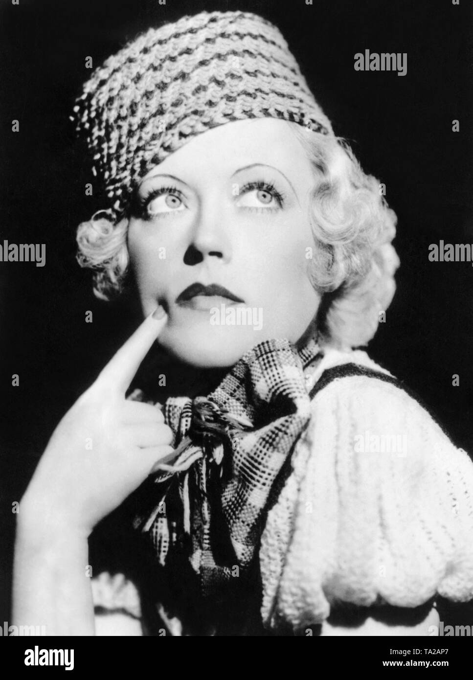 The American actress Marion Davies wears a handmade, Russian-style turban made of green and yellow yarn. Stock Photo