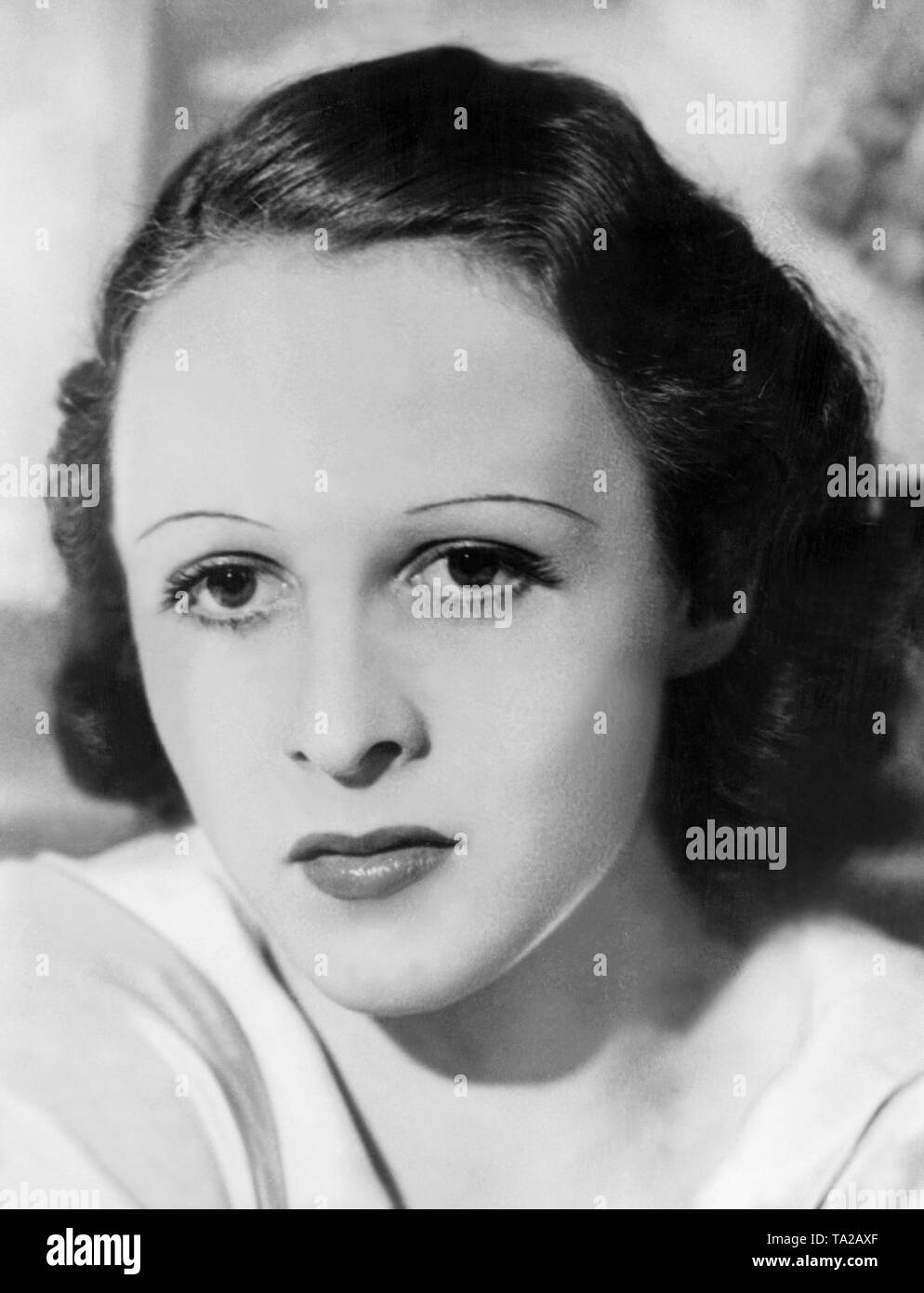 Woman with a short hairstyle of the 1930s. The thin eyebrows are also typical for the time. Stock Photo