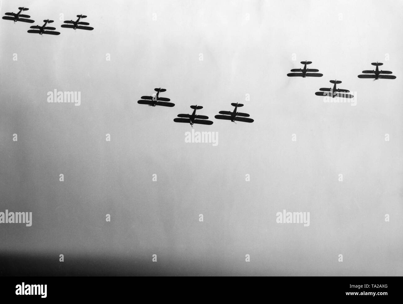 On the occasion of a major air show on 22.03.1936 on the airfield of Berlin-Staaken, 250,000 spectators have gathered to watch the squadrons, demonstrations of the anti-aircraft artillery and the aerobatics of the Luftwaffe. The picture shows the Richthofen staffel in the air. Stock Photo