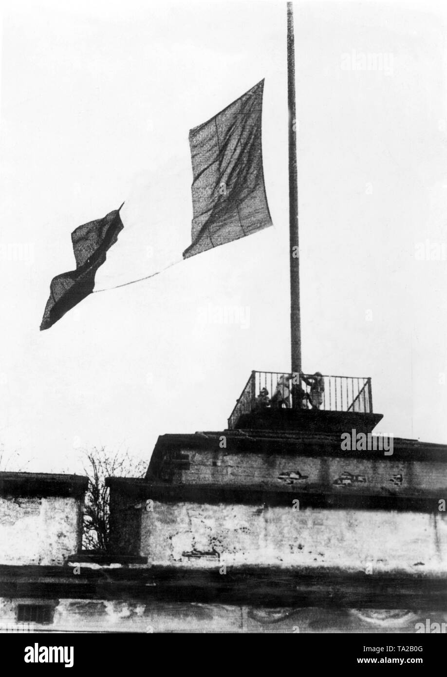 In the course of the evacuation of the fortress by the French occupation troops, the waving tricolor was also lowered. Stock Photo