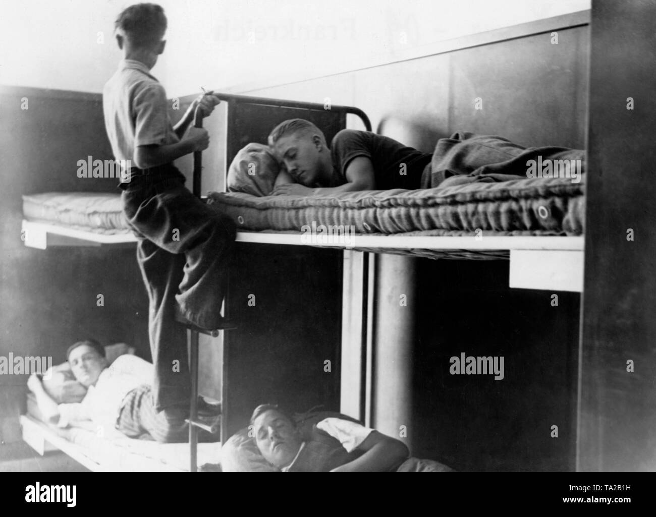The Comite de la Jeunesse de France has set up an accommodation, which serves as a shelter for released young French prisoners of war. Young men in a bedroom. Stock Photo