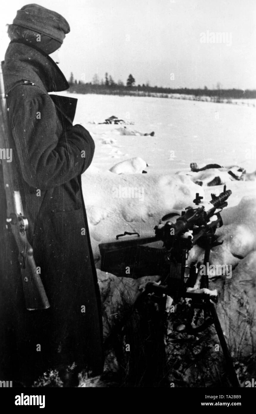 A German soldier keeps guard armed with an MG 34. Photo of the Propaganda Company (PK): war correspondent Ulrich. Stock Photo