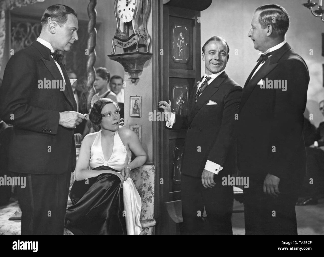 Hans Zesch-Ballot (left), Flockina von Platen as Gina Stern, Heinz Ruehmann as racing cyclist Willy Streblow and Fritz Odemar as attorney Lissmann (right) in the film comedy 'Stroke by the Bill' (German: Strich durch die Rechnung) by Alfred Zeisler. The plot of the film is based on the novel by Fred Antoine Angermayer. Stock Photo