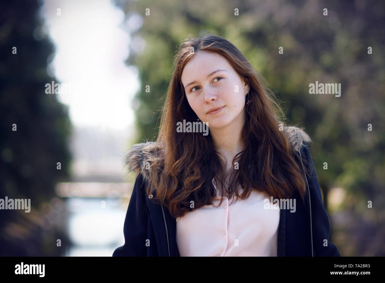 Portrait Of A Beautiful Long Haired Girl In A Coat And Pink Blouse