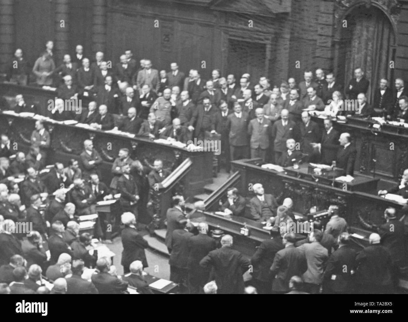 Chancellor Heinrich Bruening (on the right at the lectern) answers in a speech to the criticism of the opposition. On the government bench are recognizable: Vice Chancellor Hermann Dietrich (DDP), Interior Minister Wilhelm Groener (independent) and Transport Minister Gottfried Treviranus (KVP). Stock Photo