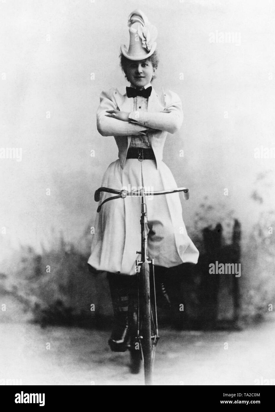 From game to sport - a bicycle artist in her sports costume. Stock Photo