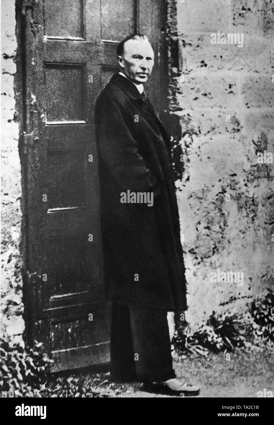Konrad Adenauer stands in front of a door in the Maria Laach Abbey. After his dismissal as mayor of Cologne in 1933, Adenauer lived there for a while. Stock Photo