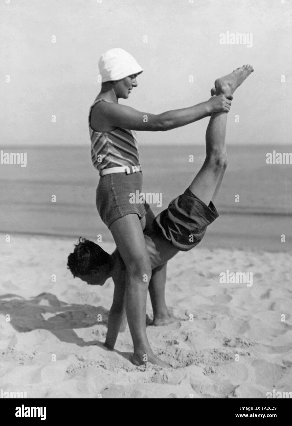 A woman and a man doing a partner exercise in the 1930s or 1940s (undated shot). Photo: Wanda von Debschitz-Kunowski. Stock Photo