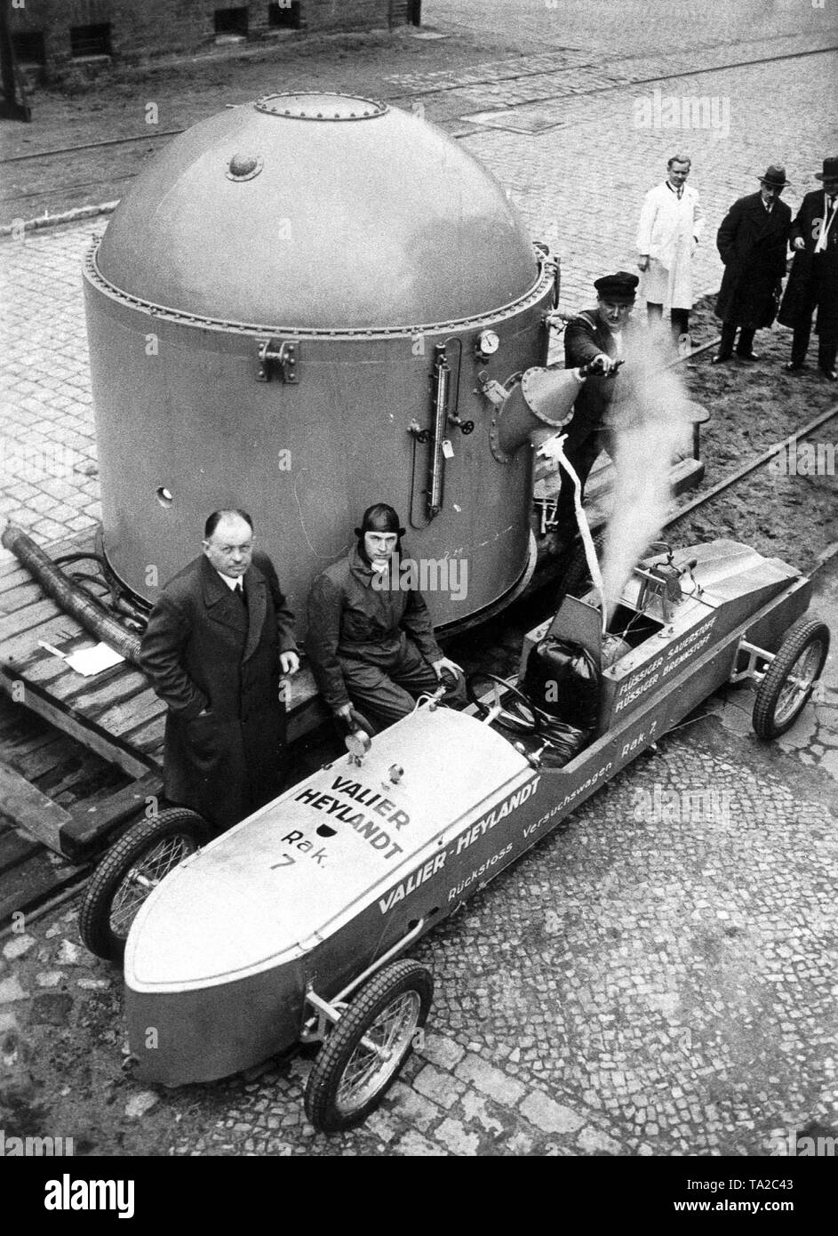 The engineer Max Valier (r.) and P. Heylandt (l.) when refueling their rocket car with liquid oxygen. Stock Photo