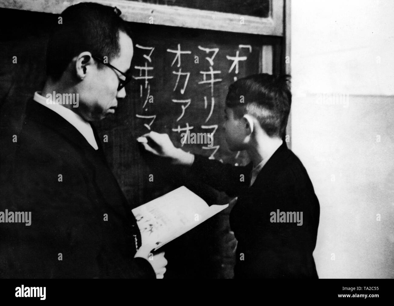 On the occasion of the anniversary of the German-Japanese cultural agreement, Japanese language was accepted as a teaching subject at the SS Heimschule Joachimsthalsches Gymnasium in Templin. Here, a boy is writing Japanese characters on the blackboard. Photo: Baltol Stock Photo
