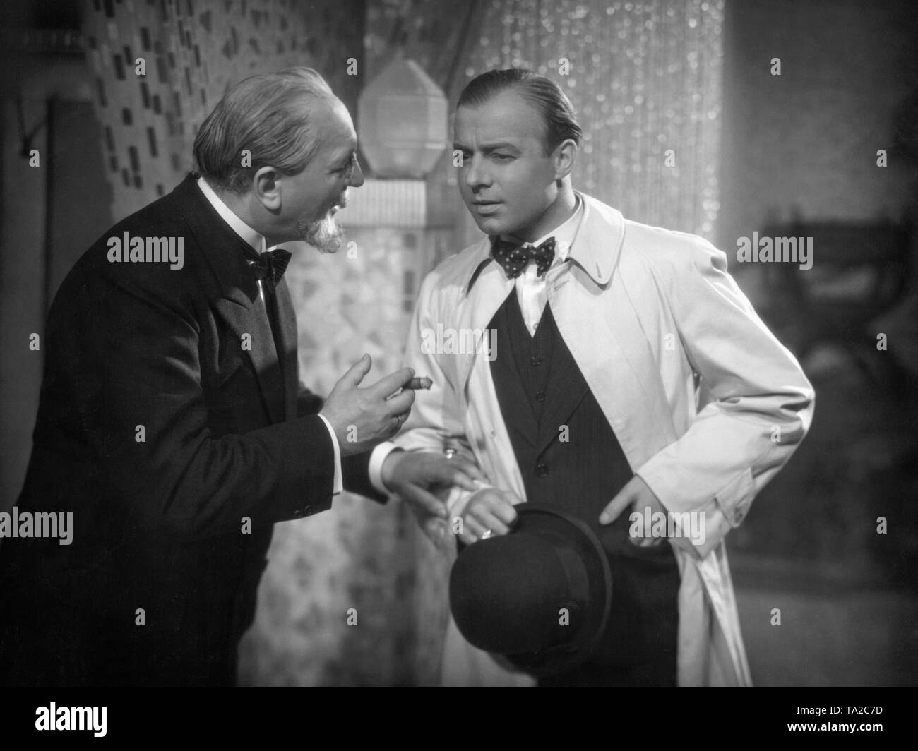 Heinz Ruehmann as waiter Karl Kramer (right), who aims high and Paul Bildt as privy councilor Donon in 'The Roundabouts of Handsome Karl' (German: Die Umwege des schoenen Karl), directed by Carl Froehlich. Stock Photo