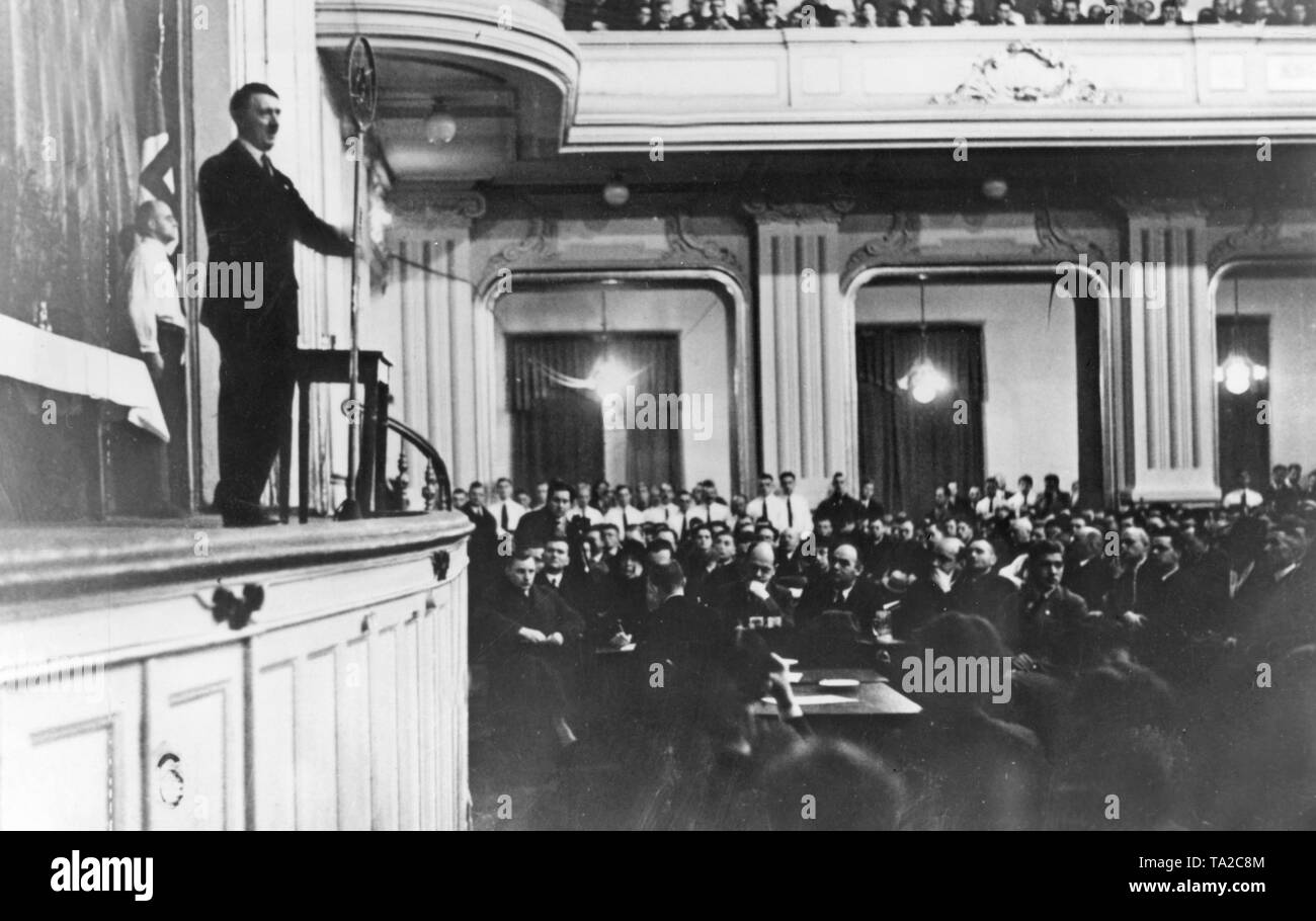 At a campaign rally of the NSDAP a speech is being delivered before the bourgeois audience. At the back of the room are SA men in white upper shirts (because of the uniform ban). Stock Photo