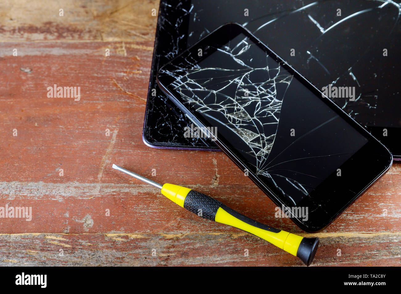 Broken smart phone and tablet on cracked touch screen process of mobile