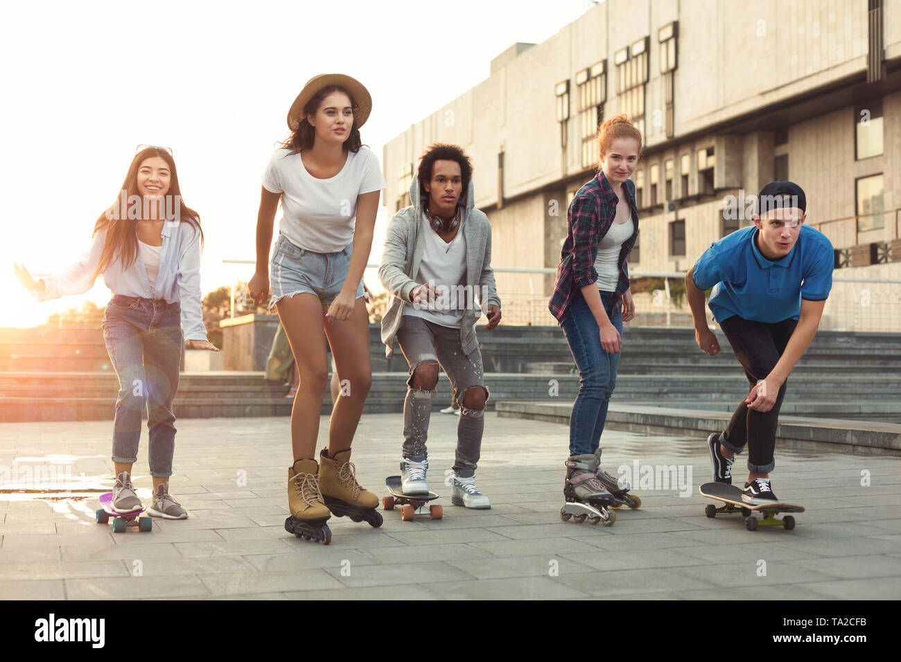 Group of teens making activities in urban area Stock Photo