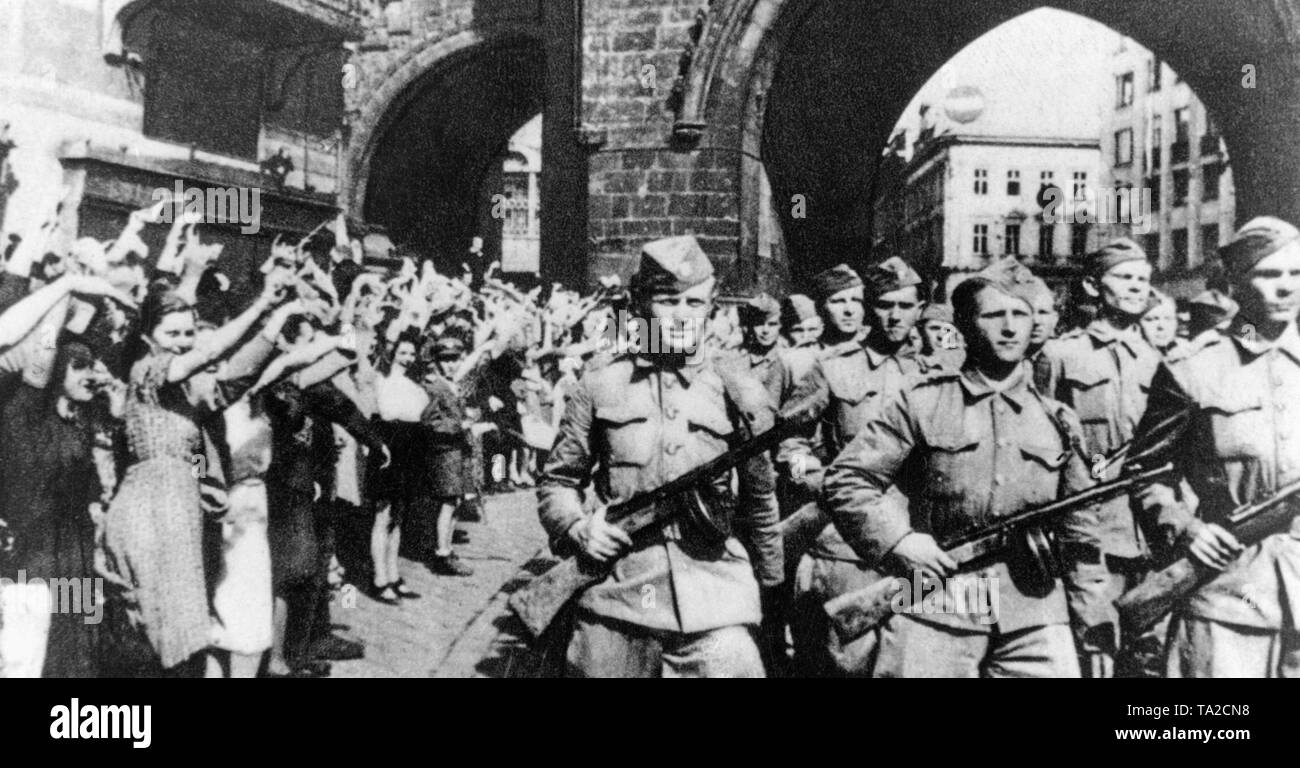 The partisan brigade Jan Zizka marches through the Powder Tower in Prague. The Wehrmacht withdrew from Prague during the Prague uprising. Stock Photo