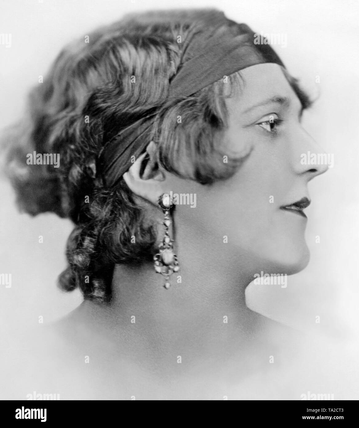 Portrait of a woman from the 1920s. Her hair is held back by a hair band. Stock Photo