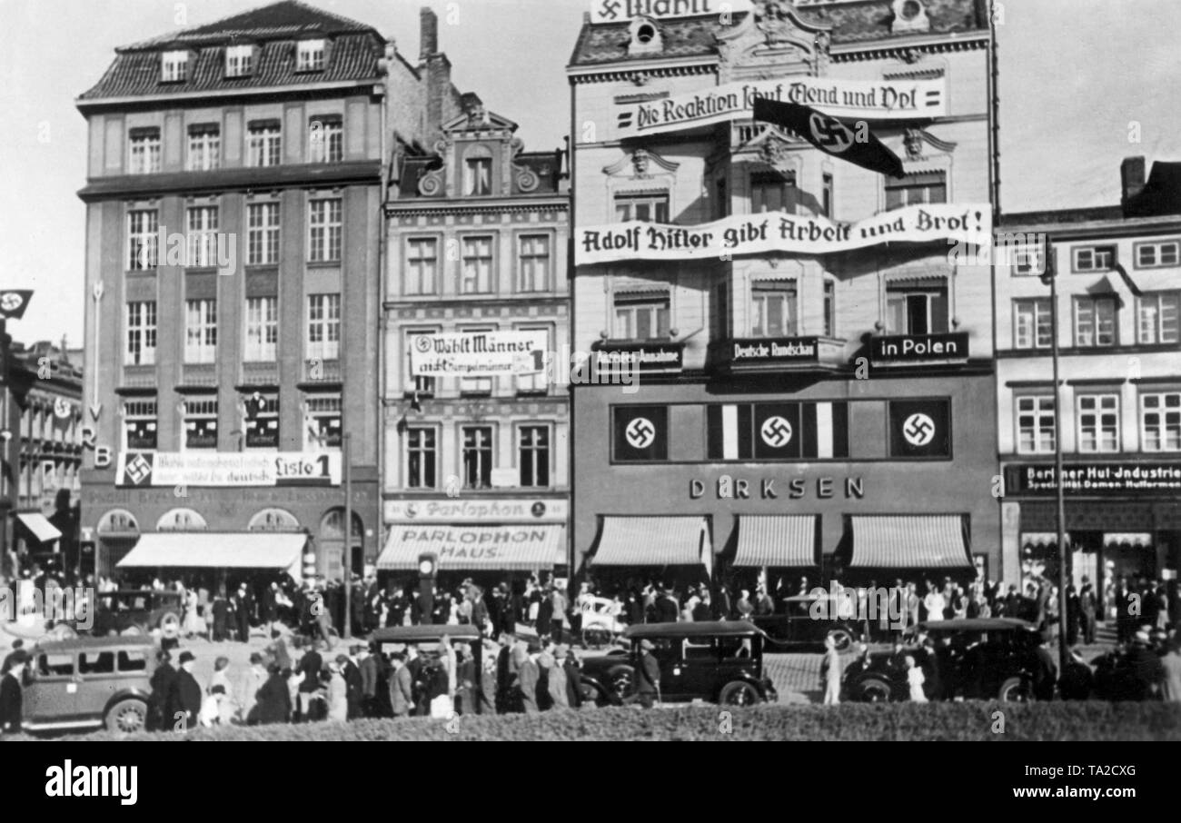 National Socialist election banners hanging on the Haus der Deutschen Rundschau in Gdansk on the occasion of the Volkstag elections. On a banner: 'The reaction created misery and distress. Adolf Hitler gives work and bread!'. On another: 'Vote for men not for jumping jacks' and 'Vote for the National Socialists, therefore vote for the German List 1' Stock Photo