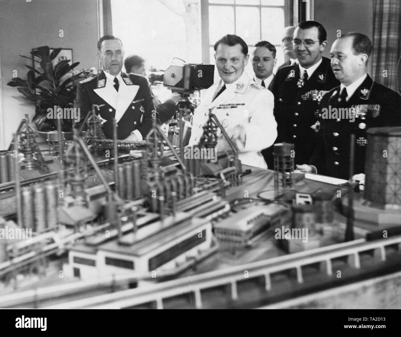 Karl Bodenschatz (on the left) and Hermann Goering (in the middle) visit the model of a hydrogenation plant for the manufacture of synthetic gasoline Stock Photo