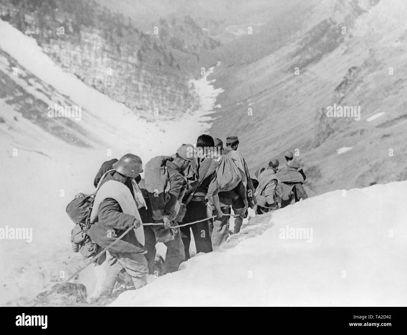 Photo of a group of Republican fighters descending a mountainside in the Pyrenees with full field kit forming a clique. Early in 1939, more than 5,000 Republican soldiers fled to France, partly on steep mountain trails over the Pyrenees from the Aragon front and the advancing Spanish national troops. Stock Photo