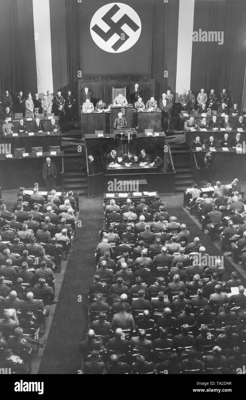 The Nazi Interior Minister Wilhelm Frick (at the lectern) speaks at the opening of the Reichstag in the Berlin Kroll Opera. As president of the Reichstag, Hermann Goering. Stock Photo