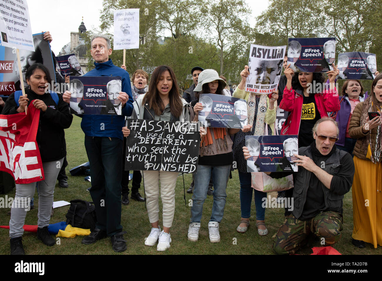 Protesters including rights campaigner Peter Tatchell calling to free Julian Assange outside Parliament on 24th April 2019 in London, England, United Kingdom. The Wikileaks founder Julian Assange was arrested and is currently serving a prison sentence after he was found guilty of breaching the Bail Act and on 1 May 2019 was sentenced to 50 weeks in prison in the United Kingdom. Peter Tatchell is a British human rights campaigner, originally from Australia, best known for his work with LGBT social movements. Stock Photo