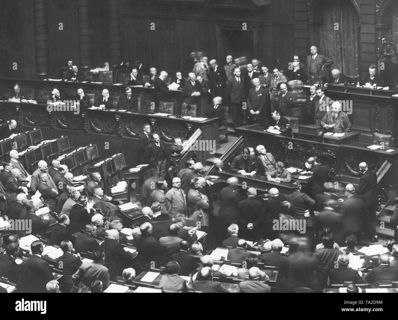 The deputy of the Centre Party, Thomas Esser (right half of the picture, at the lectern with a note in his hand) gives a speech at a Reichstag meeting. Stock Photo