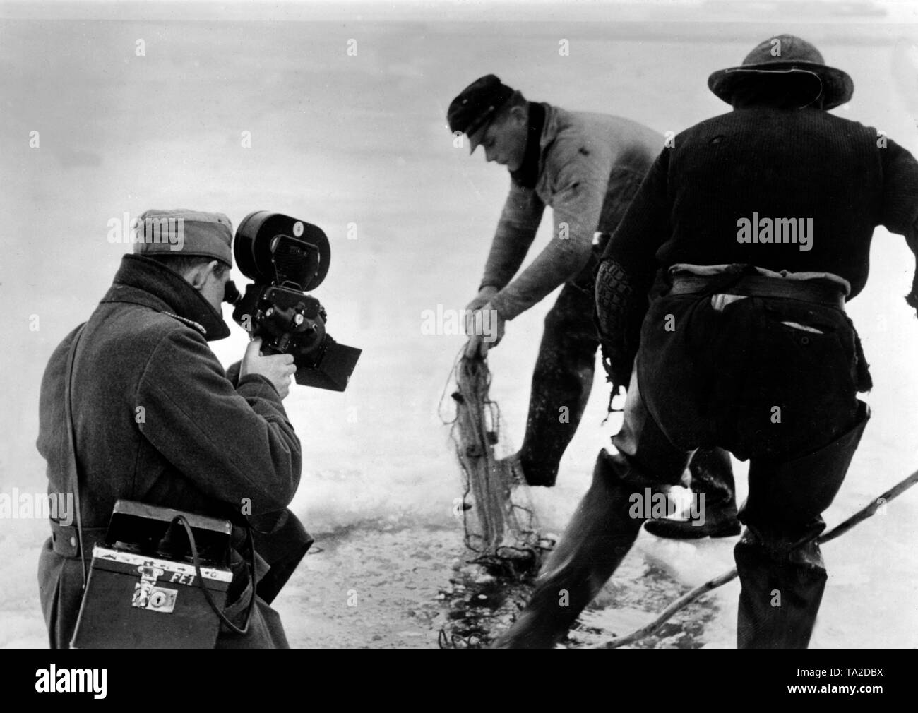 War correspondent of a propaganda company at ice fishing. Photo of the Propaganda Company (PK): War correspondent Foltinek Stock Photo