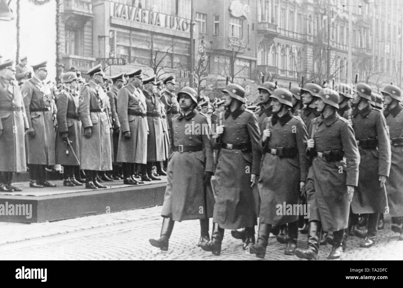 On the occasion of the anniversary of the establishment of the Protectorate of Bohemia and Moravia, a military parade takes place at Wenceslas Square. The troops march past the VIP stand. Stock Photo