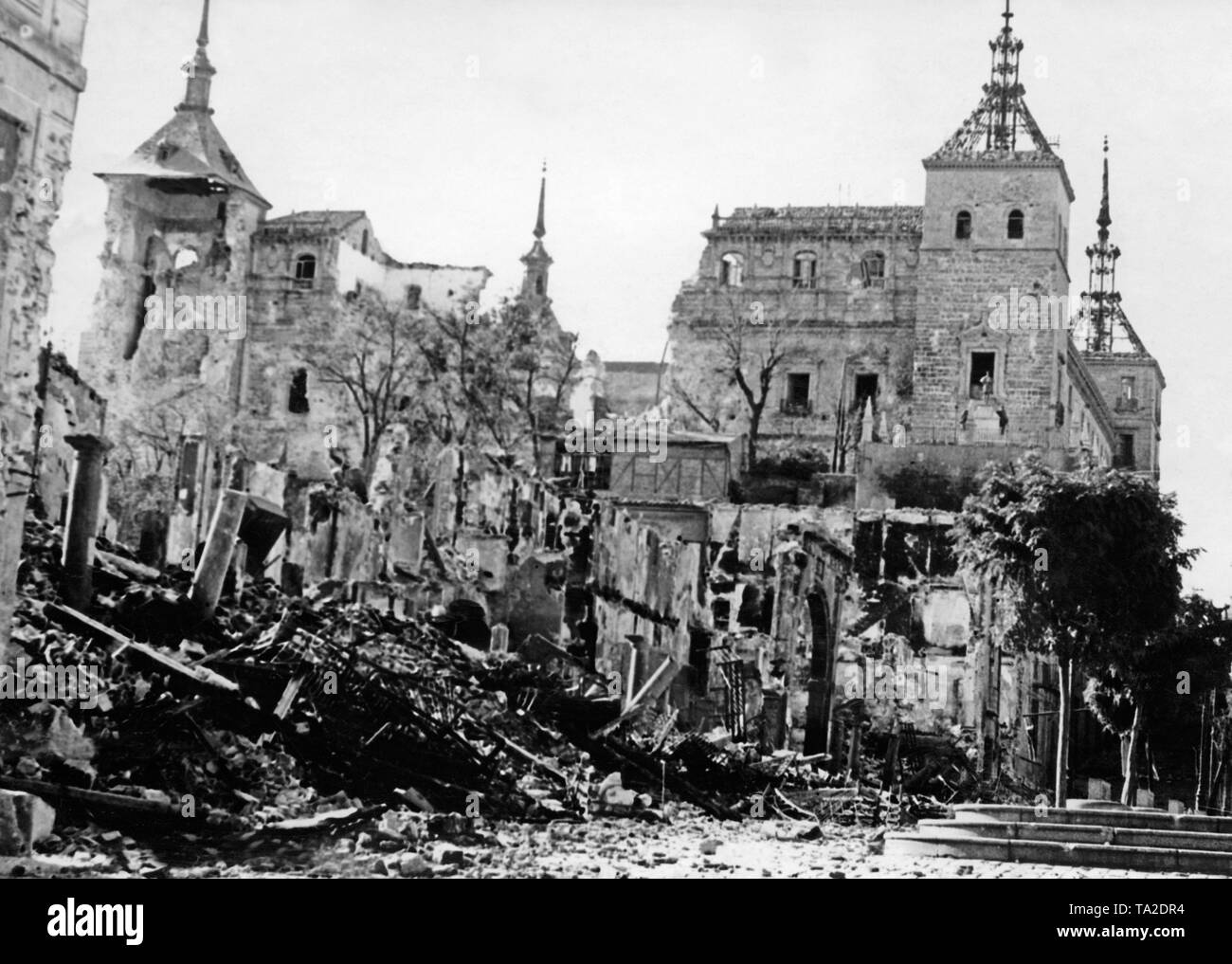 Photo of the partly destroyed Alcazar of Toledo after it had been liberated by Spanish national troops on September 26, 1936. Here, the partially collapsed walls and the four towers of the fortress. Stock Photo