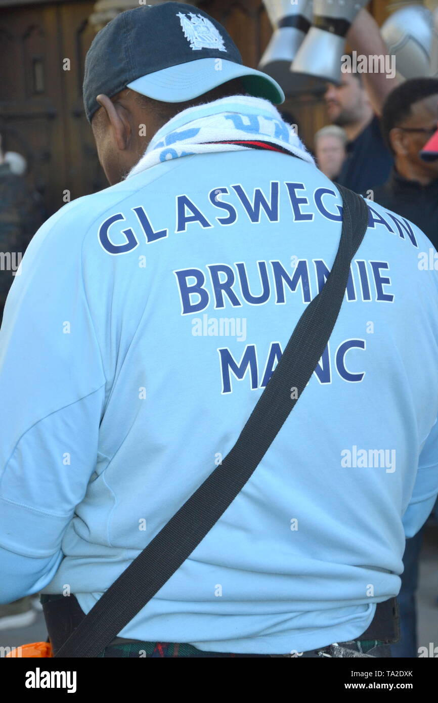20th May, 2019. An MUFC supporter waits for Manchester City Football Club Champions Trophy Parade beside Manchester Town Hall Stock Photo