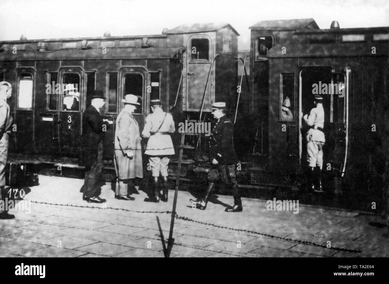 French gendarmes control the travelers at the station of Vohwinkel. Officers of the French army pay attention to the proper conduct of the inspection. In the foreground the platform was secured with barbed wire in order to prevent passengers from getting in the train uncontrolled. Stock Photo