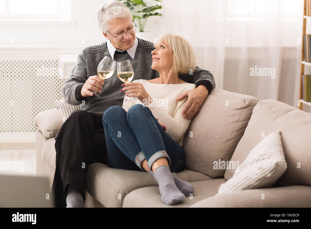 Mature Couple Drinking White Wine At Home Stock Photo