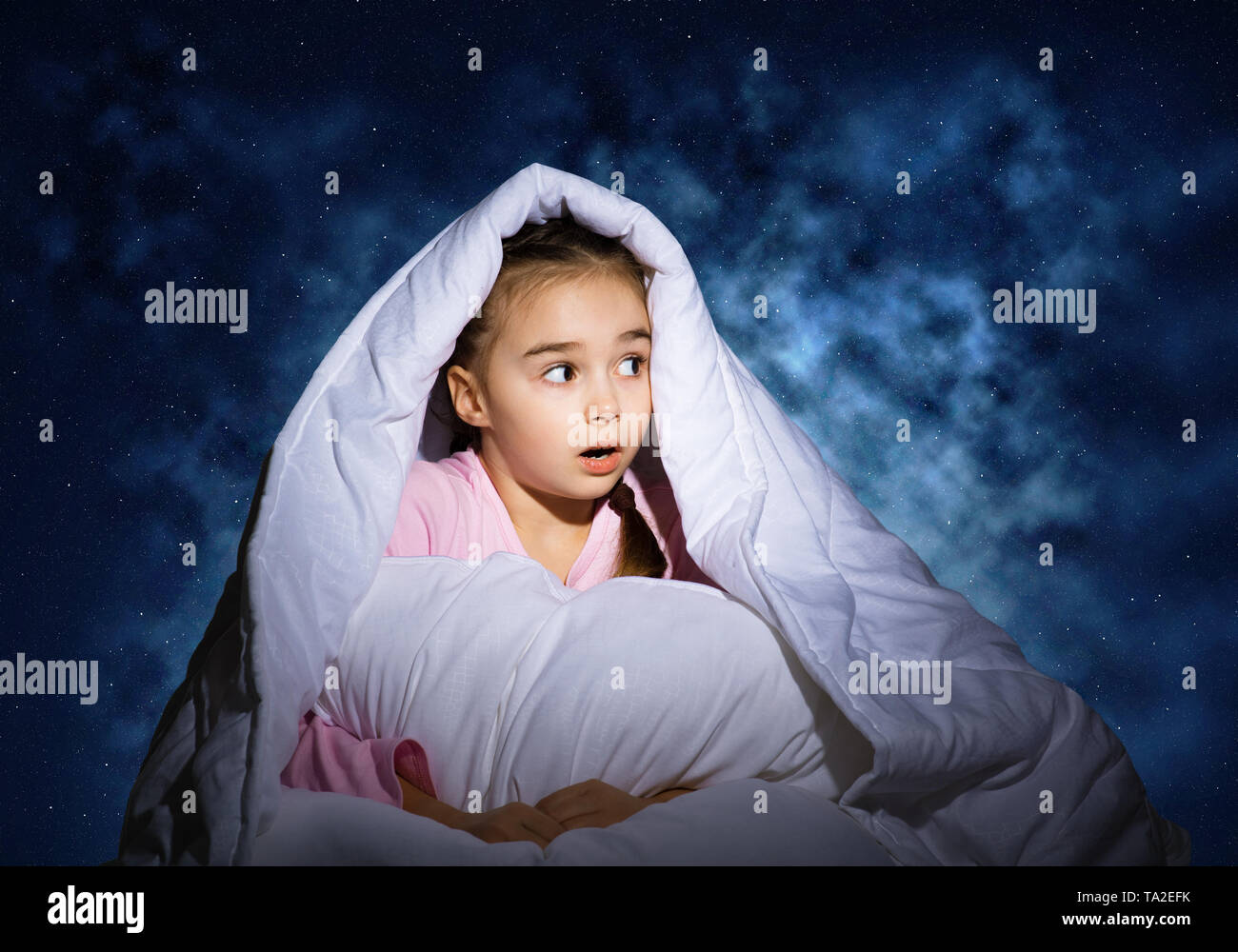 Surprised child hiding under blanket Stock Photo Alamy