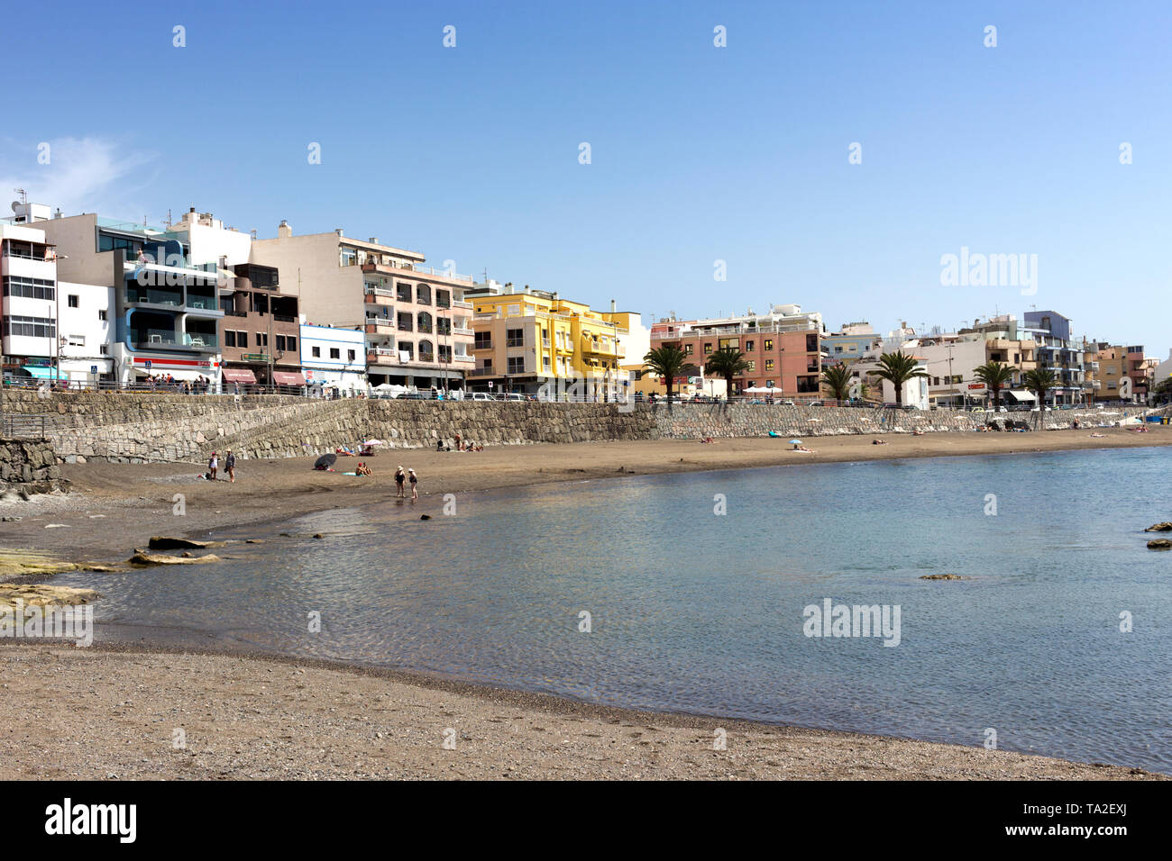 Gran Canaria, Spain - March 14, 2019:  Arguineguin, people enjoy relax on the beach. Arguineguin is one of the most populated towns along the south co Stock Photo