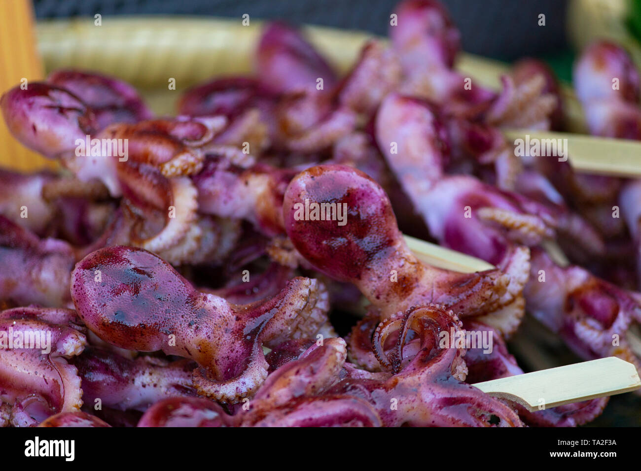 Mini octopus skewers ready to be grilled at a food stall in Enoshima