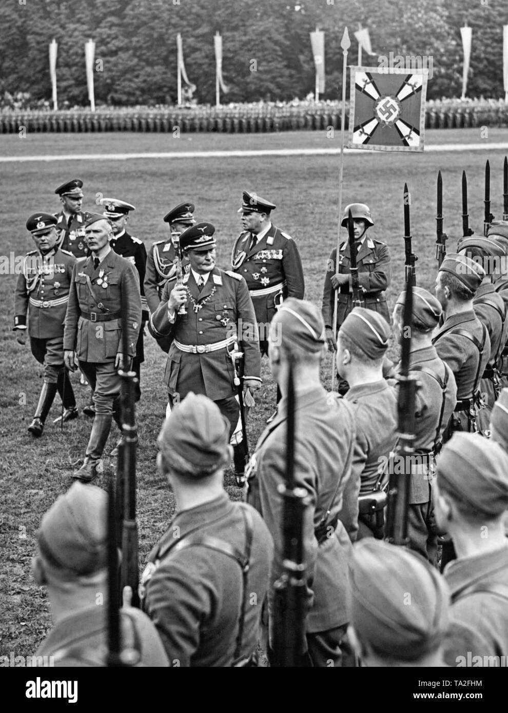 Photo of Field Marshal General Hermann Goering (in the front on the right) who is inspecting the line of the legionaries with the commander of the Condor Legion, Major General Wolfram Freiherr von Richthofen (left) in the Moorweide in Hamburg. Behind, from left to right: General of the Cavalry Wilhelm Knochenhauer, General der Flieger Helmuth Volkmann, General Admiral Conrad Albrecht, Colonel-General Erhard Milch and General der Flieger Hugo Sperrle. Stock Photo
